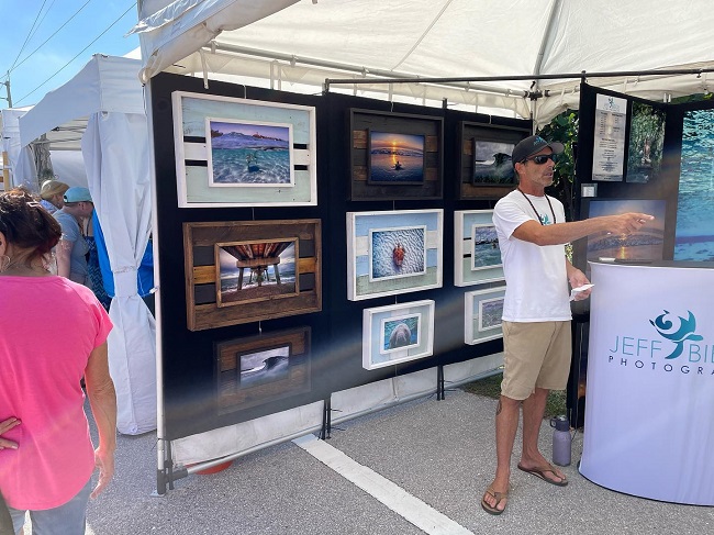 people viewing metal prints on display